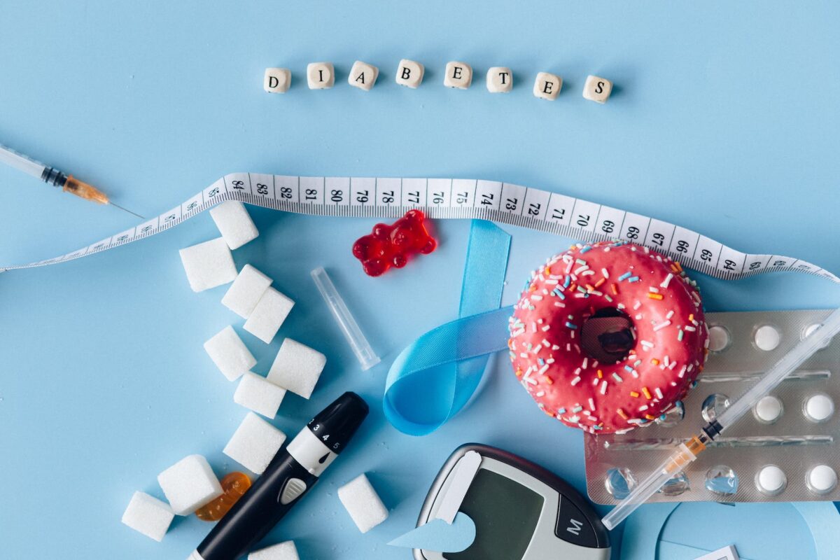 blood sugar meter and sweets on the blue background